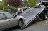 Salem NH Towing loading up a Flat Bed Tow Truck
